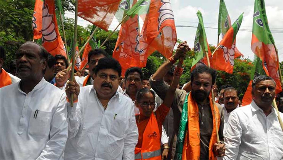 BJP Telangana President  G Kishan Reddy with party MLAs, MLCs  and GHMC workers staging a protest in support of sacked municipal staff, at Indira Park in Hyderabad on Saturday